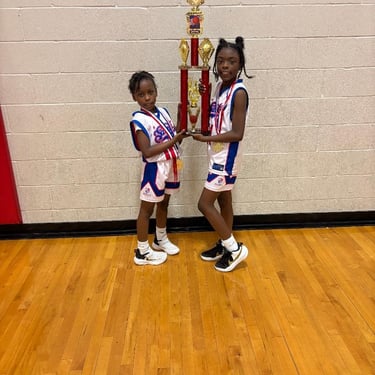 Kamari and London raise the Championship Trophy for the Saint Phillip Saints! 