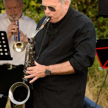 Musician plays on a saxophone during concert in Duxford. Author: Slawek Dejneka