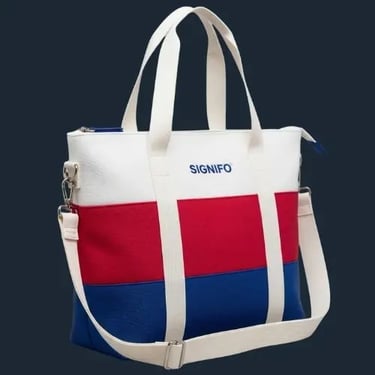 Tas selempang kanvas SIGNIFO dengan kombinasi warna maritim klasik: biru benhur, merah, dan putih.