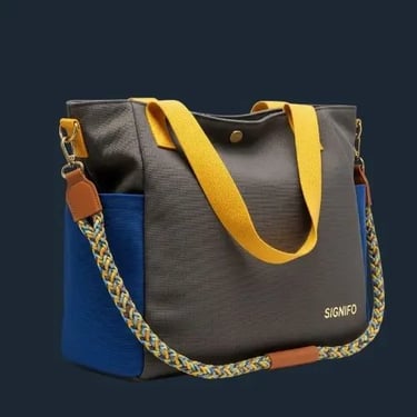 Tas jinjing metropolitan SIGNIFO dari kanvas biru benhur dan abu-abu dengan tali kuning cerah.