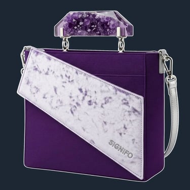 A sharp, geometric tote with an asymmetrical, angular flap, reminiscent of crystal facets.