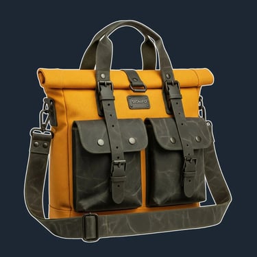 A sturdy, structured tote with a fold-over top flap secured by straps, similar to a classic field bag.