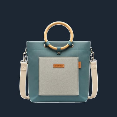 A minimalist tote with a clean, upright, rectangular shape, featuring an innovative folded construction that minimizes visibl