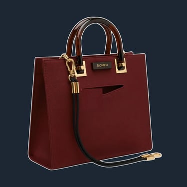 A sleek, minimalist tote with a rigid, geometric body and an unusual, asymmetrical top line.