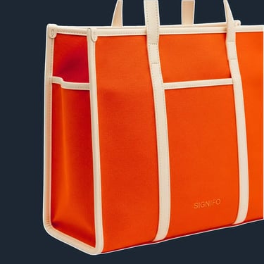 A clean, minimalist tote with a very simple, upright rectangular shape. The bag's panels are joined with prominent, external