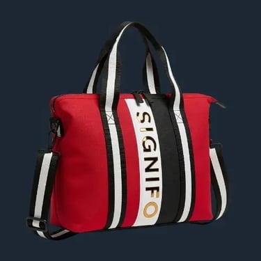 Tas travel SIGNIFO dari kanvas merah dengan aksen garis-garis hitam dan putih yang modern.