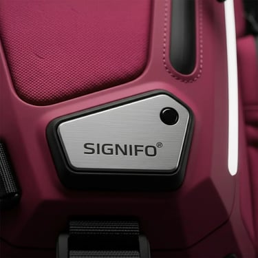 Close-up logo 'SIGNIFO' pada plat metal yang terpasang di sling bag futuristik.