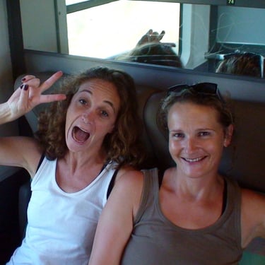 headshot of two backpackers on a train in France