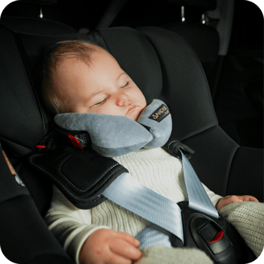a baby in a car seat with a sleeping pillow sleepfix