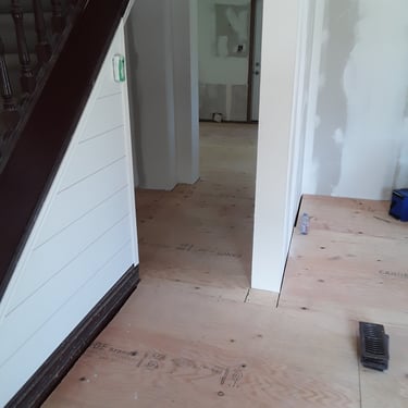 Levelled plywood subfloor installation in progress during full interior renovation of a residential home