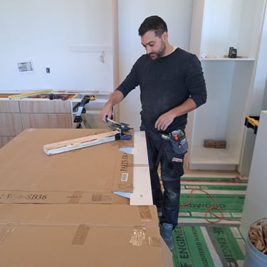 Professional contractor measuring materials during kitchen renovation project in residential home