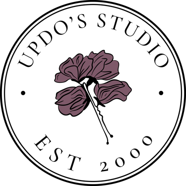Updo’s Studio circular badge logo with mauve floral emblem, elegant serif type, wedding hair and makeup brand.