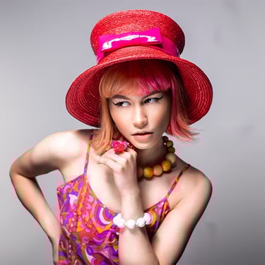 a woman with a red hat and a pink dress