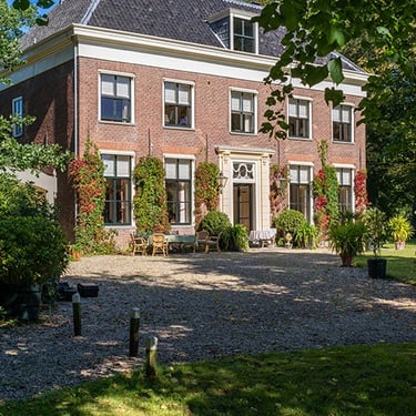 a large house with a large driveway and a gravel path
