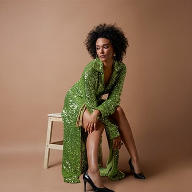 a woman in a green dress and high heels