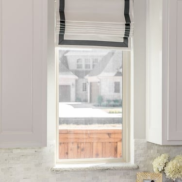 White flat roman shade with gray accent banding kasmir fabric