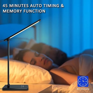 a woman sleeping in bed with a lamp on a table