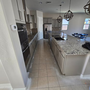 Freshly refinished white kitchen cabinets with a smooth, professional finish, enhancing the space with a clean and modern loo
