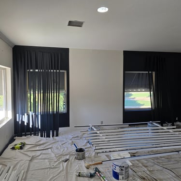 Black slat accent wall with vertical panels, creating a bold and sophisticated focal point behind the bed