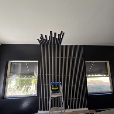 Bold black slat wall feature behind bed, blending minimalist design with dramatic contrast for a luxury bedroom look.