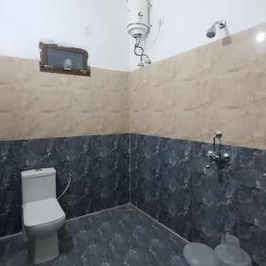 Bathroom at hotel rudra near jolly grant airport