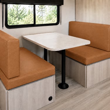 Modern RV interior featuring a light oak dinette table with Wallaby Camel cushions.