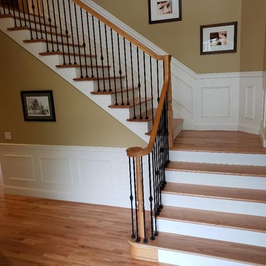 Vision Flooring and More installed solid oak treads over stairs as well as new iron balusters.