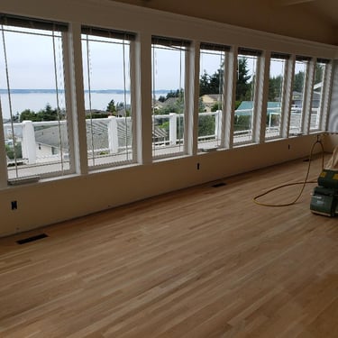 Vision Flooring sanding oak floors with belt sander. Nice waterfront home.