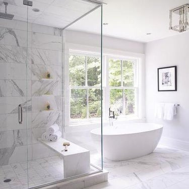 Vision Flooring and More bathroom remodeling. Light color marble tiles with standing tub.