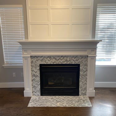 Vision Flooring and More installed new trim over fireplace and wall above. New trim and painting.