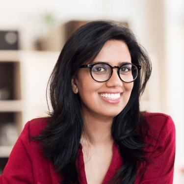 a woman in a red shirt and glasses