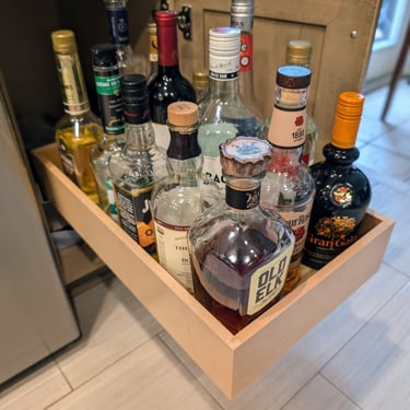 Roll outs for cabinets that are holding beverage bottles.