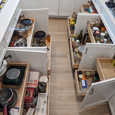 Kitchen base cabinet pull outs extended to show contents.
