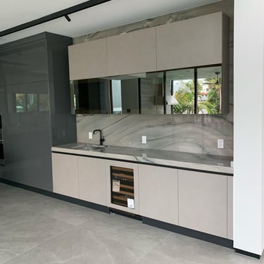 a kitchen with a large counter top and a refrigerator