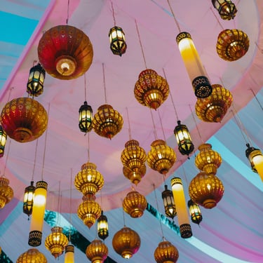 Lanterns hanging from the ceiling, glowing with purple lighting.