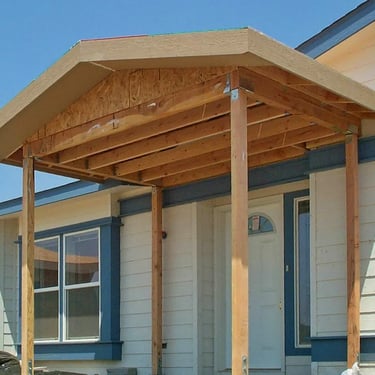 Rough framing of gabled entry cover over front door