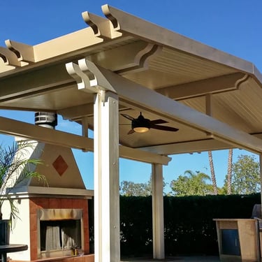 Freestanding Alumawood gazebo with peaked roof and fireplace.