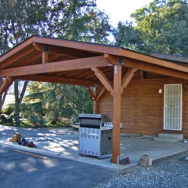 Freestanding 2-car wood carport finished with semi-transparent stain.
