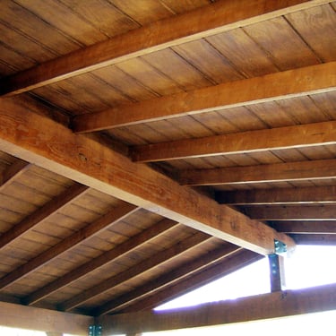 Resawn wood raftes and T111 sheathing finished with semi tranparent stain.