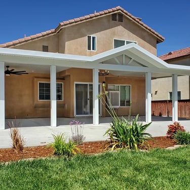 White Alumawood patio roof with gabled center section.