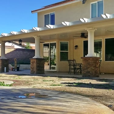 Large Alumawood structure with Stone column bases and decorative rafter tails.