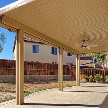 Gazebo roof attached to home with wooden fence.