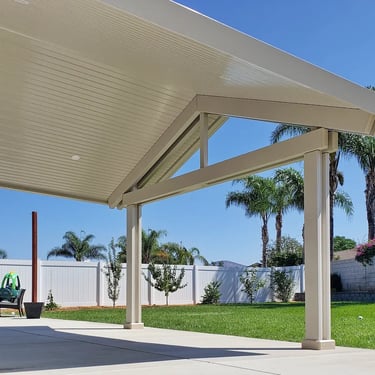 Peaked roof cover and green lawn.