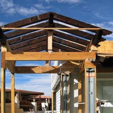 Tall gabbled roof structure being erected.