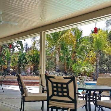 Table and chairs, poolside under Alumawood.