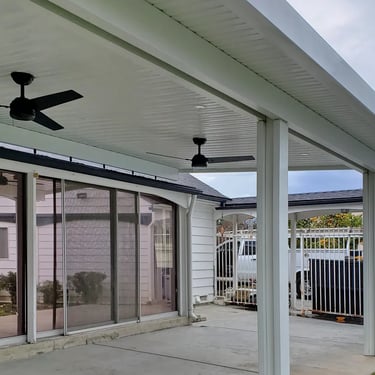 White roof mounted Alumawood with black ceiling fans.
