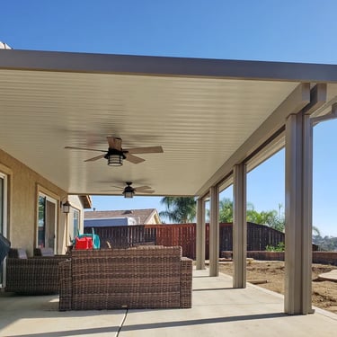 Outdoor furniture under solid patio cover.