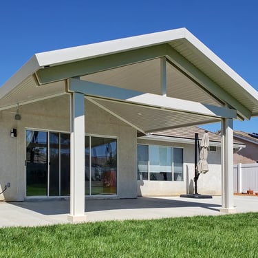 Patio cover with gable roof line attached over sliding glass door.