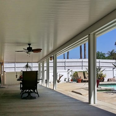 Solid patio roof cover next to pool.