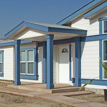 White and blue gabled entry cover over front door.